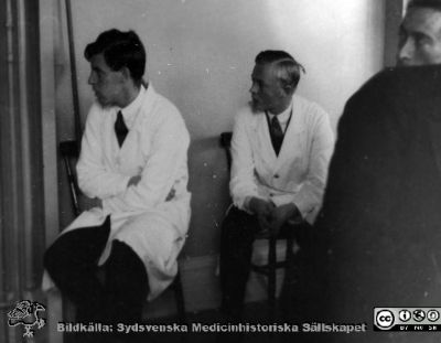Bild i fotoalbum  tillägnat professor Torsten Hellman från deltagarna i histologikursen ht 1930. 
Fotoalbum  "TILL PROFESSOR TORSTEN hELLMAN MED TACK FRÅN DELTAGARNA I HISTOLOGIKURSEN HÖSTTERMINEN 1930".  Bildtext "Bäst att höra på". Två kursamanuenser i stora föreläsningssalen. Från vänster troligen Moberg, sedan en okänd.
Bildkälla stifteleen Locus Medicus Lundensis och Sydsvenska Medicinhistoriska Sällskapet / SMHS. Fotograf okänd.
Nyckelord: Histologiska avdelningen;Anatomiska Institutionen;Entrétrappa;Medicinska fakulteten i Lund;Sydsvenska Medicinhistoriska Sällskapet;Locus Medicus Lundensis;Lärare