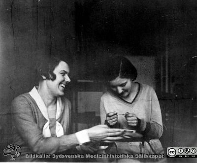 Fotoalbum tillägnat professor Torsten Hellman från histologikursen HT 1930
Fotoalbum  "TILL PROFESSOR TORSTEN HELLMAN MED TACK FRÅN DELTAGARNA I HISTOLOGIKURSEN HÖSTTERMINEN 1930".  Bildtext "MOT SLUTET. Det blivande albumet inför sakkunniga.".  Kanske är det Lisa Svenander Lanke till vänster tillsammans med okänd medicine studerande. Foto kanske i institutionens kurslaboratorium
Bildkälla stiftelsen Locus Medicus Lundensis och Sydsvenska Medicinhistoriska Sällskapet / SMHS. Fotograf okänd.
Nyckelord: Histologiska avdelningen;Anatomiska Institutionen;Medicinska fakulteten i Lund;Sydsvenska Medicinhistoriska Sällskapet;SMHS;Locus Medicus Lundensis;Elever