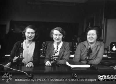 Fotoalbum  från histologkursen 1931.  Bildtext "E. Andersson, M. Dahlgren, M. Jönsson".  Tre medicine studerande i mikroskoperingssalen. 
Bildkälla Stiftelsen Locus Medicus Lundensis 250317. Sydsvenska Medicinhistoriska Sällskapet / SMHS. Fotograf okänd.
Nyckelord: Histologiska avdelningen;Anatomiska Institutionen;Locus Medicus Lundensis;Medicinska fakulteten i Lund;Medicine studerande;Elever