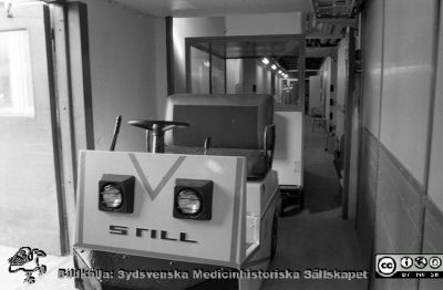 Patienttransport i kulverten med elektrisk truck och "passagerarvagn"
Sjukhusfotograferna i Lund. Pärm Svart-vita neg. 1987. 87-09-29. Från negativ.
Nyckelord: Lasarettet;Lund;Universitetssjukhus;USiL;Patient;Transport;Kulvert;Tåg