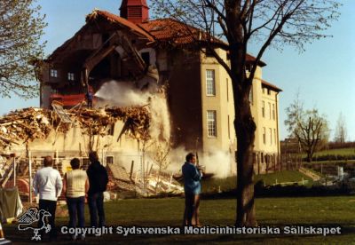 En gammal paviljong rivs år 1980
Vipeholm exteriört. Paviljong A rivs år 1980. Foto, omonterat
Nyckelord: Vipeholm;Exteriört;Rivning;Paviljong;Foto;Omonterat;Kapsel 15;1980