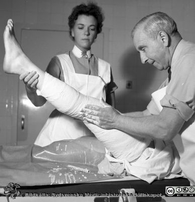 Docent Sophus von Rosen i Malmö gipsar ett knä år 1957
Pärm äldre neg. 1951-1958 MAS, från fotograf Björn Henrikssons samling. Påskrift: "Doc. Von Rosen, gipsning, 13/9-57". Knägipsning. Från negativ
Nyckelord: UMAS;MAS;Malmö;Allmänna;Sjukhus;Ortopedi;Gipsning;Knä