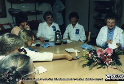 Ortopediska kliniken i Lund 1987. Sjukgymnasten Aina Karlsson avtackas.
Från ortoped klin album 01, Lund. Fotograf Berit Jakobsson.  1987. Avtackning, sjukgymnasten Aina Karlsson, längst till höger i bilden. Därtill avdelningsföreståndare Gunilla Persson bortom kaffekannan.
Nyckelord: Lund;Universitetssjukhus;USiL;Kliniker;Ortopedi;Personal;Avtackning;Fest;Fysioterapeuter;Sjuksköterskor