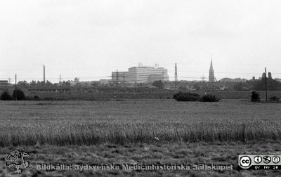 Universitetssjukhuset i Lund med omnejd
Lasarettsfotograferna i Lund,  pärm  Sv/v Negativ, 1985. 85/62. Universitetssjukhuset i Lund med omnejd från en åker i sydväst. Allhelgonakyrkan till höger och panncentralens skorsten till vänster. Från negativ
Nyckelord: Lasarettet;Lund;Universitetssjukhuset;USiL;Centralblocket