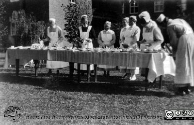  Skolköksafslutningen den 23/8 1930". Troligen på SSSH i Lund. 
Kapsel 30. I kuvert märkt "Bilder donerade av Gunnel Ringblom 890804". Påskrift: "Skolköksafslutningen den 23/8 1930". Troligen på SSSH i Lund. Originalfoto, omonterat.
Nyckelord: Kapsel 30;Sköterskor;Avslutning;SSSH