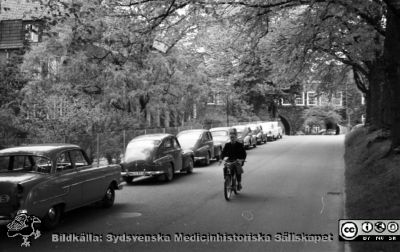 Lasarettet i Lund vid Sandgatans förlängning, senare Lasarettsgatan (1961)
Pärm "Div. tagningar 1960 och t.v.". Foto 1961. Foto mot norr. Gamla medicinska kliniken till vänster. Valvet som förbinder reumatologiska och de medicinska klinikerna i fonden. Kanske är det rimfrost på träden? Eller är de alldeles nyutslagna? Film no.27. Från negativ.
Nyckelord: Lund;Lasarett;Universitetssjukhus;Universitet;USiL;Medicin;Klinik;Reumatologi