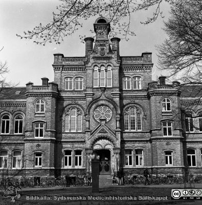 Huvudentrén till 1867 - 68 års kirurgiska klinik i Lund
Sjukhusfotograferna i Lund. Pärm Negativ 1981:1.	58. Gamla kirurgiska kliniken från sydost, byggd 1867-68 och nu sedan ~10 år i Lunds Universitets ägo och använd som studentcentrum. Foto: ER. Från negativ.
Nyckelord: Lasarettet;Lund;Universitetssjukhuset;USiL;Kirurgisk;Klinik;Administration