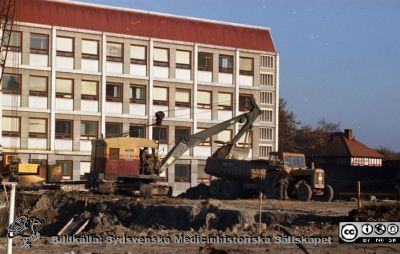 Grävning för det blivande centralblocket
Pärm Lasarettsfoto, interiörer och exteriörer m.m. 1958 - 1960. Gropen grävs framför AB-blocket för det blivande C-blocket.  Från negativ
Nyckelord: Lund;Lasarett;Universitet;Universitetssjukhus;USiL;Blocket;Bygge;Grävning