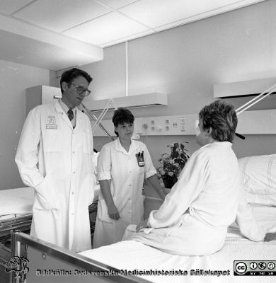 Professor Berndt Ehinger 1987
Sjukhusfotograferna i Lund. Pärm Negativ, Dia, 1987. 96/87. Professor Berndt Ehinger vid en patient på ögonkliniken i Lund 1987 tillsammans med syster Eva-Kajsa Lundström. Från negativ. 
