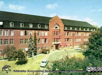 Universitetssjukhuset i Lund, norra området
Lasaettet. Lund. Medicinska kliniken. Byggnaden rymmer sedan 1972 hudkliniken och kallas numera Hudhuset. Efter tryckt vykort. Lasarettskiosken Allan Wahlström, Lund. Bilarna på uppfarten till kliniken tycks köra i vänstertrafik, som avskaffades 1967.
Nyckelord: Lund;Lasarett;Vykort;Internmedicinsk;Klinik