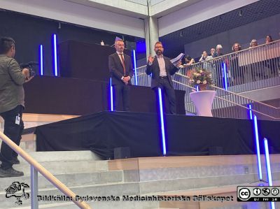 Vid invigningen av Forum Medicum i Lund. 
Rector Magnificus Erik Renström invigningstalar som intervjuad av en okänd man. Foto Lars Malm 2023-08-30.
Nyckelord: Forum Medicum;Medicinska fakulteten;Lunds universitet;Invigning;Forskning;Utbildning