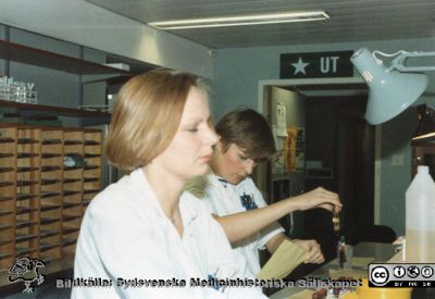 Från Boel Ohlsson 2016, Klin.kem. lab.  Lund. 	Boel Ohlsson och Eva Almström
Nyckelord: Laboratorium;Lasarettet;Lund;foto nära 1984;Universitetssjukhuset;USiL;Klinisk;Kliniskt;Kemiska;Avdelningen