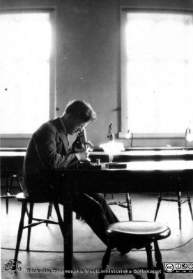 1928 års kurs i histologi i Lund
Fotoalbum märkt Histologikursen anno 1928. 
Detta album innehåller bilder från dåvarande histologiska avdelningen på anatomiska institutionen i Lund på Biskopsgatan 7. Liksom de övriga i serien skapades det av kursdeltagarna och tillägnades kursledaren professor Torsten Hellman som uppskattning av hans lärargärning. Bildtext  "Den ensamme prep.-läsaren Rudolf Lindqvist". Student vid kursmikroskop.
Bildkälla Stiftelsen Locus Medicus Lundensis 250317.
Nyckelord: Locus Medicus Lundensis;Medicinska fakulteten i Lund;Histologiska avdelningen;Sydsvenska Medicinhistoriska Sällskapet;SMHS;Anatomiska Institutionen;Studenter